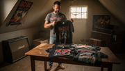 Collector sorting authentic vintage metal T-shirts