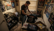 Collector sorting vintage heavy metal T-shirts