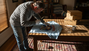 Collector inspecting vintage band shirt fabric