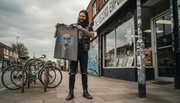Metalhead examining vintage band shirt outside store