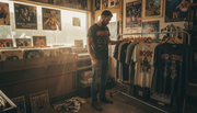 Collector browsing vintage heavy metal t-shirts