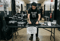 Band member setting up tour shirt merch table