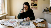 Collector examining vintage festival shirts