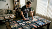 Man organizing vintage metal shirt collection