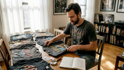 Collector sorting vintage heavy metal t-shirts
