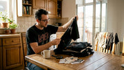 Collector inspecting vintage metal band t-shirts