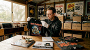 Collector inspecting rare vintage metal tee