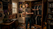 Man browsing vintage metal t-shirts in closet