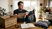 Collector examining vintage band shirts
