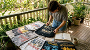 Collector examining vintage band shirts at table