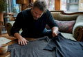 Collector comparing vintage and reissue shirts on table