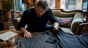 Collector comparing vintage and reissue shirts on table