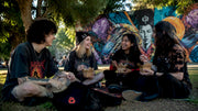 Group wearing subculture merch outdoors