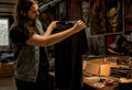 Collector examining vintage metal tee in room