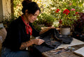 Woman inspecting vintage band shirt for restoration
