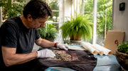 Man inspecting vintage metal tour shirt