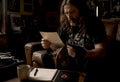 Collector examining metal shirt and certificate