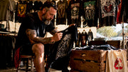 Collector inspecting a vintage band shirt closely