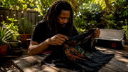 Collector inspecting vintage concert T-shirt at home