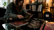 Collector inspecting metal vinyl and shirt set