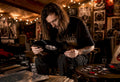 Person inspecting doom metal vinyl record in room