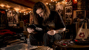 Person inspecting doom metal vinyl record in room