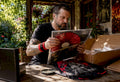 Collector examining rare vinyl and t-shirt bundle