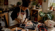 Woman crafting upcycled band tee tote bag