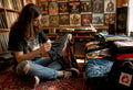 Person browsing vintage heavy metal T shirts