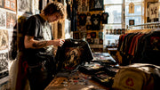 Fan inspecting a vintage Sepultura t shirt in bedroom