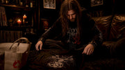 Collector inspecting black metal underground shirt