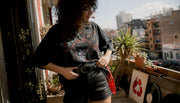 Woman styling oversized vintage shirt indoors