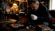 Collector inspecting pristine deadstock metal shirt