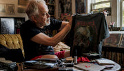Collector examining vintage Metallica tour shirt