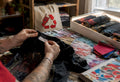 Hands inspecting tag and stitching of vintage tour shirt