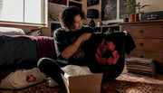 Person unboxing fan club edition shirt at home