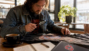 Collector inspecting vintage metal band t-shirt closely