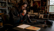 Collector inspecting vintage shirt at home workspace