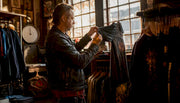 Man examining vintage t-shirt stitching