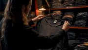 Hands holding vintage band t-shirt to light