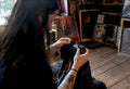 Hands inspecting vintage metal shirt collar and hem