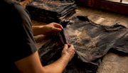 Hands inspecting vintage band shirt neck tag