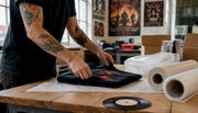 Hands folding vintage metal t shirt for shipping