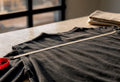 Tape measuring vintage garment width