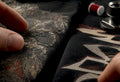 Fingers comparing two vintage print textures