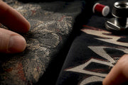 Fingers comparing two vintage print textures